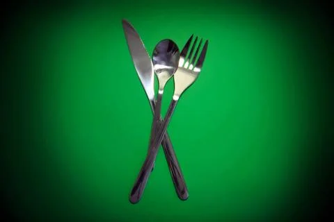 Table serving-dishware on green backdrop. Stock Photos