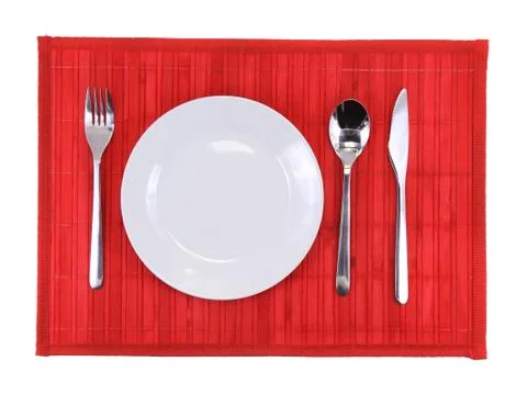 Table serving-dishware on red backdrop. Stock Photos