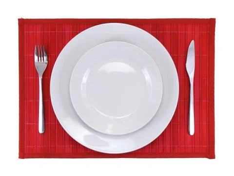 Table serving-dishware on red backdrop. Stock Photos