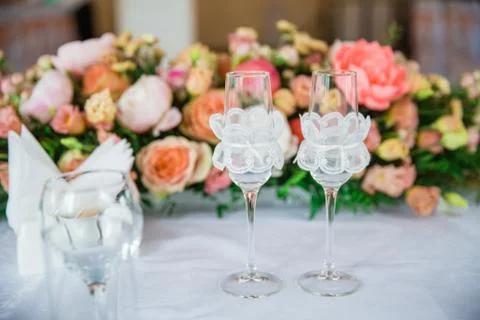 Table serving with glasses and flowers in hall Stock Photos