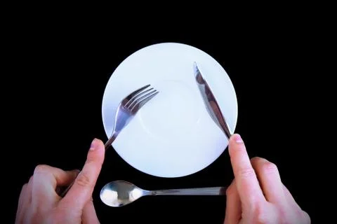 Table serving-knife, fork in hands Stock Photos