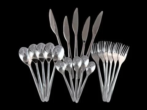 Table serving-knife,spoon,fork on black backdrop. Stock Photos