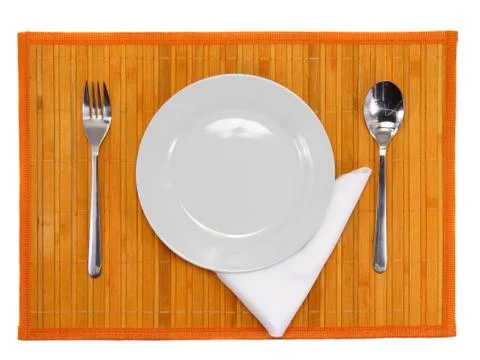 Table serving-knife,spoon,fork on colour backdrop. Stock Photos