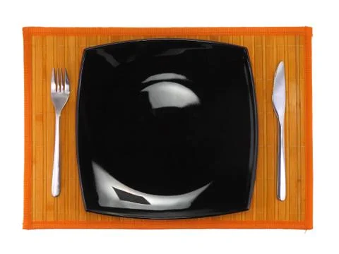 Table serving-knife,spoon,fork on colour backdrop. Stock Photos