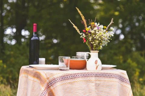 Table is set and waiting for dining in the countryside. Vintage color tone Stock Photos