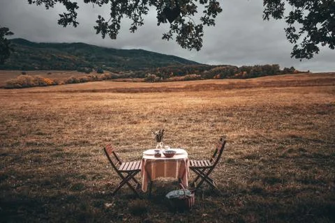 Table is set and waiting for dining in the countryside. Vintage color tone Stock Photos