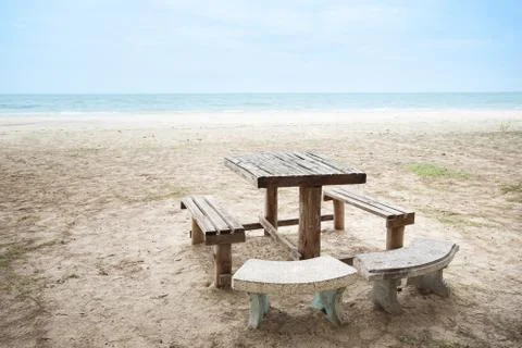 Table set with bench on the beach. Stock Photos
