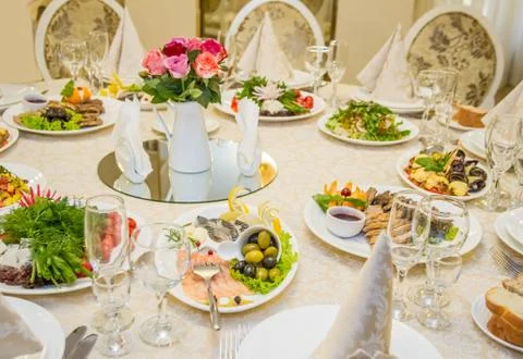 Table set for celebration in classic style with meal Stock Photos