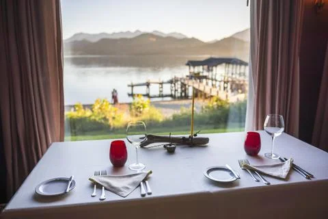 Table set up for dinner at a fine dining restaurant with wine glasses and Stock Photos