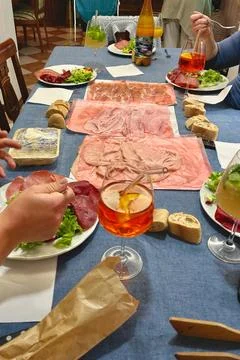 The table is set for dinner with meat cuts and cocktails Stock Photos