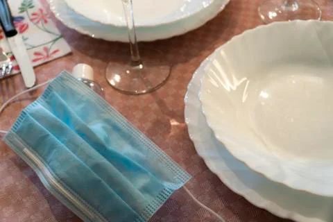 Table set up with dinnerware and silverware, ready for a meal. with surgical Stock Photos