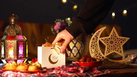 A table set for Eid with festive treats and wrapped gifts 写真素材