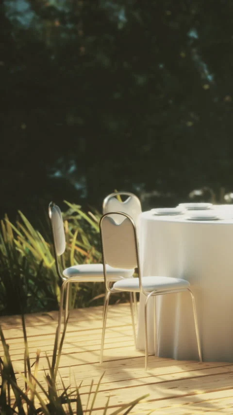 Table set for event on deck surrounded by greenery on sunny day Stock Footage 334188531
