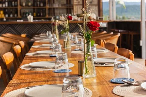 Table set for an event party with rose flower on table. Stock Photos