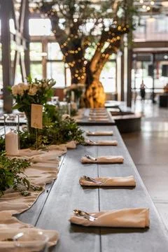 Table set up with garland and decor before wedding guest Stock Photos