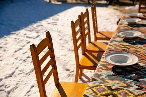 A table set for guests under the open sky in winter Stock Photos