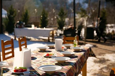 A table set for guests under the open sky in winter Stock Photos