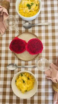 A table set for a healthy breakfast with eggs and fruit and a cup of coffee. Stock Photos