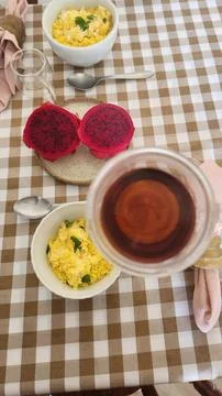 A table set for a healthy breakfast with eggs and fruit and a cup of coffee. Stock Photos