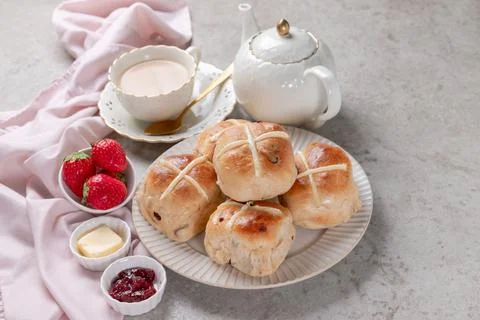 Table set with hot cross buns and tea for Easter Stock Photos