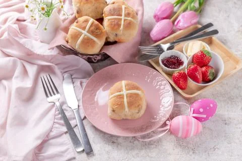 Table set with hot cross buns and tea for Easter Stock Photos
