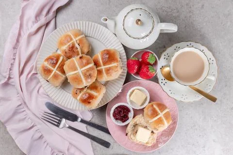 Table set with hot cross buns and tea for Easter Stock Photos