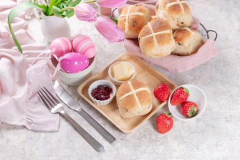 Table set with hot cross buns and tea for Easter Stock Photos
