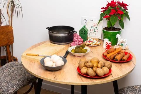 A table is set with ingredients for making Olivier salad, a traditional dish  Stock Photos