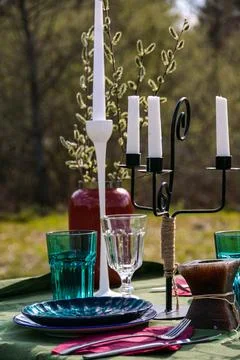 A table set in nature at the dacha in spring for lunch or dinner Stock Photos