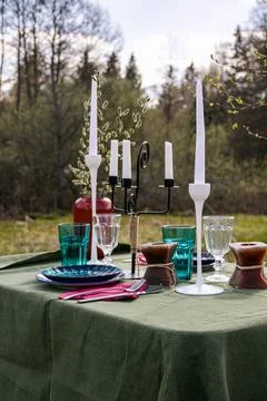 A table set in nature at the dacha in spring for lunch or dinner Stock Photos