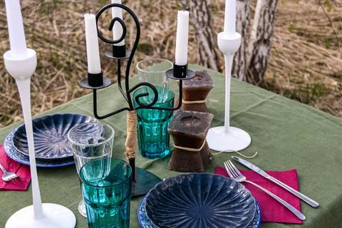 A table set in nature at the dacha in spring for lunch or dinner Stock Photos