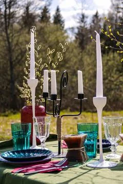 A table set in nature at the dacha in spring for lunch or dinner Stock Photos