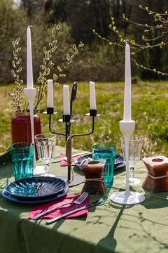 A table set in nature at the dacha in spring for lunch or dinner Stock Photos