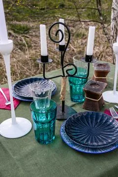 A table set in nature at the dacha in spring for lunch or dinner Stock Photos