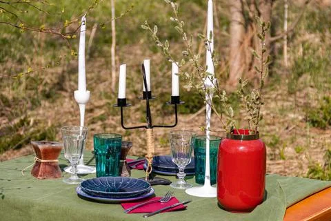 A table set in nature at the dacha in spring for lunch or dinner Stock Photos