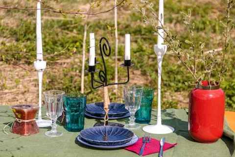 A table set in nature at the dacha in spring for lunch or dinner Stock Photos