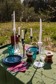 A table set in nature at the dacha in spring for lunch or dinner Stock Photos