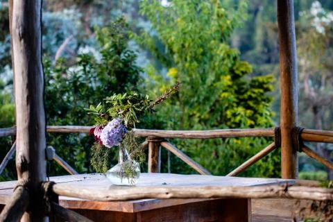 Table set in an outside hut with beatiful views to the forest Stock Photos