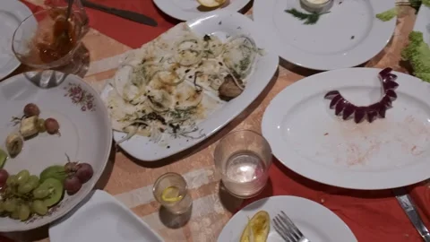 A table set with plates of food and glasses of wine Stock-Footage 314979313