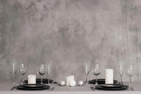 A table set in the restaurant. Serving a table. Grey artistic background. Black Stock Photos