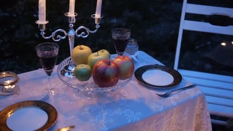The table is set for a romantic candlelight dinner outdoors Stock Footage
