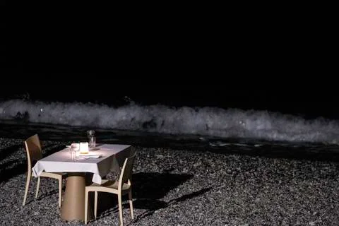 Table set for a romantic dinner on the beach 写真素材