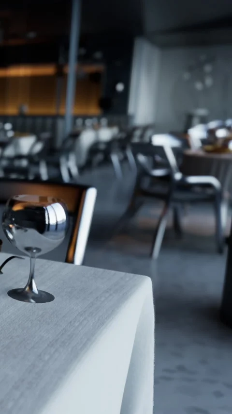 Table set with silverware in a restaurant during evening hours Stock Footage 335189717