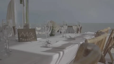 Table set up for a special event with roses and greenery outdoors Stock Footage 176916350