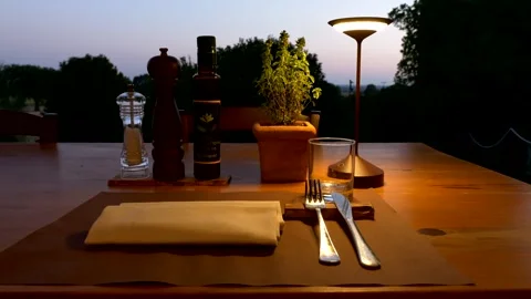 A table set in a Tuscan restaurant at sunset. Video 4K Stock Footage 332171565