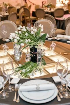 Table set for a wedding reception. the mirror reflects the ceiling 스톡 사진