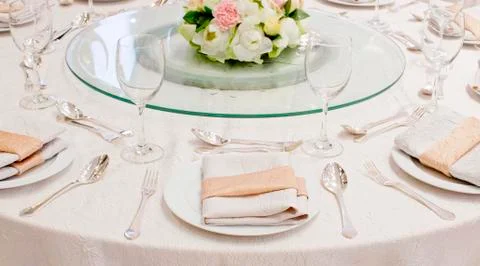 The table is set for a western style dinner with round glass on table Stock Photos
