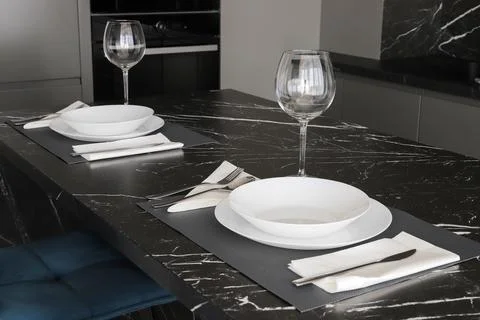 Table setting on black marble countertop 스톡 사진