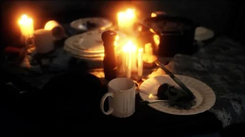 Table setting in candlelight at night Illustrazione stock