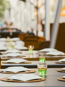 Table setting with candles and woven placemats in a restaurant Stock Photos